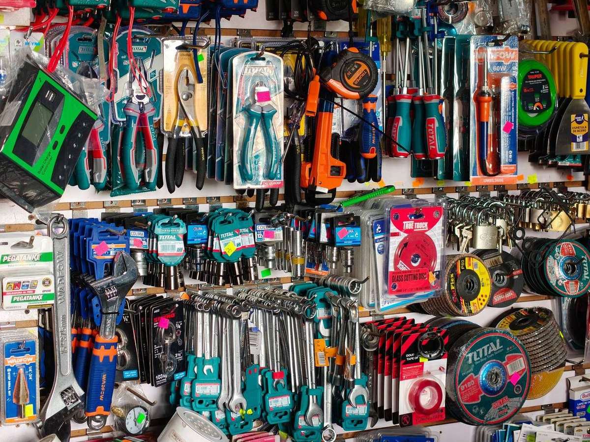 Hand tools and power tools displayed on hardware store shelves