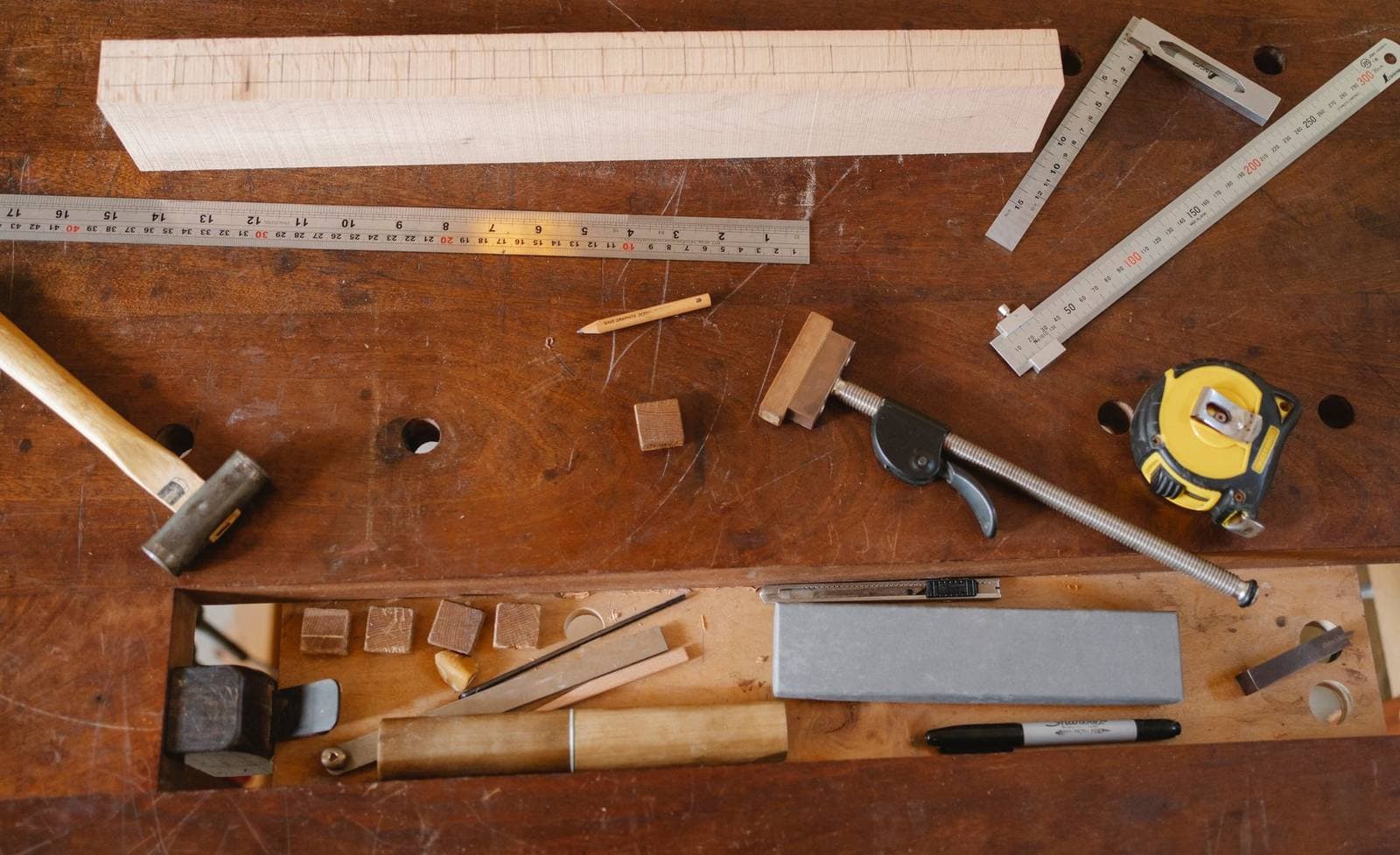 Wood chisels and marking tools arranged on a joiner workbench